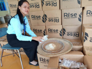 Young lady with boxes of food in Cambodia